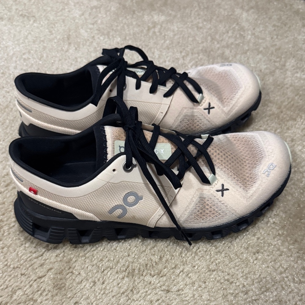 On Cloud Running Cream and Black Athletic Shoes